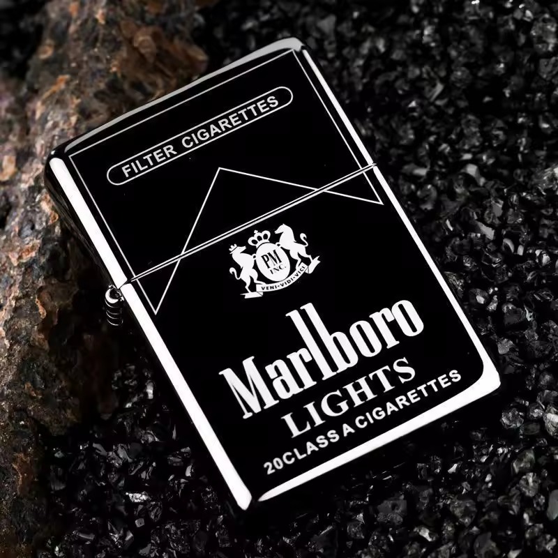 Black metal flip lighter on a dark textured surface
