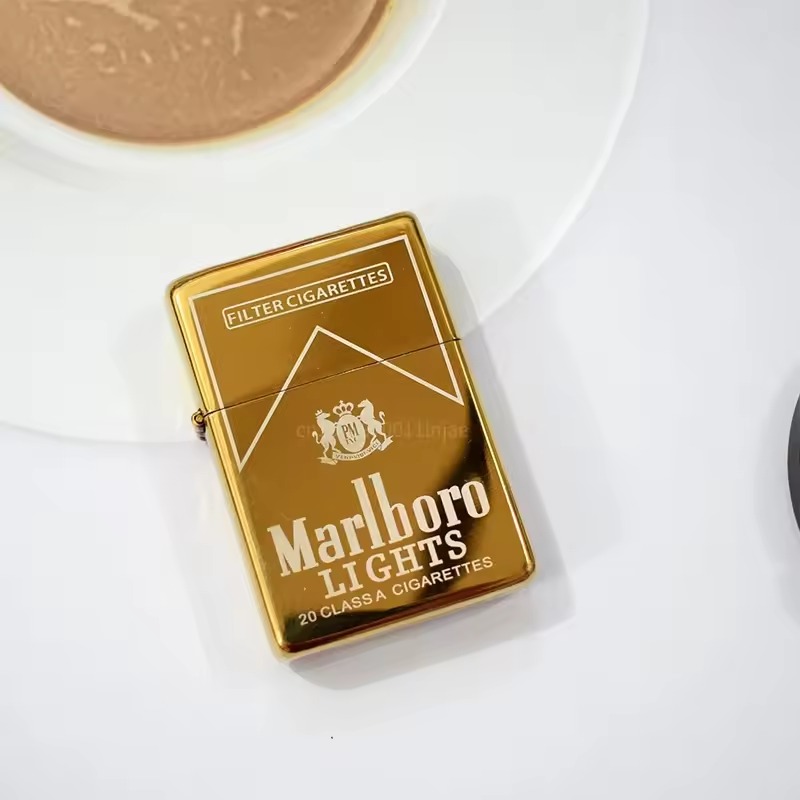 Gold metal flip lighter on a white tabletop