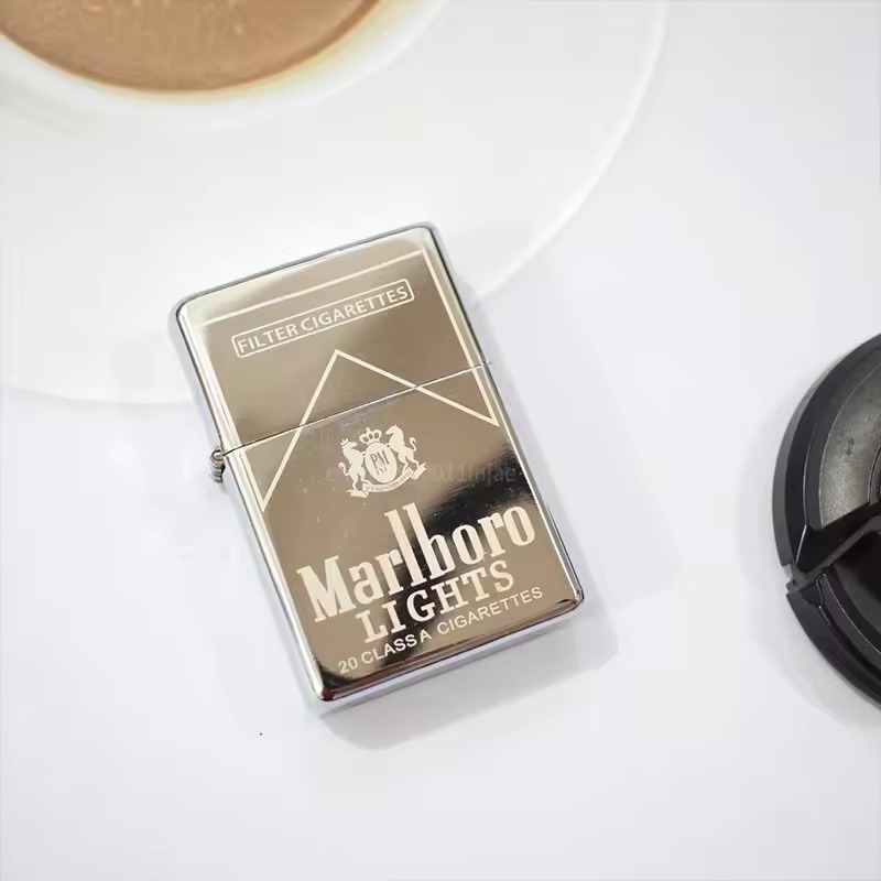 Silver metal flip lighter on a dark textured surface